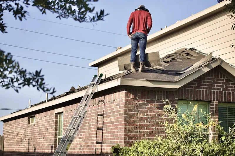 Professional roofer working on a residential roof in Little Elkton